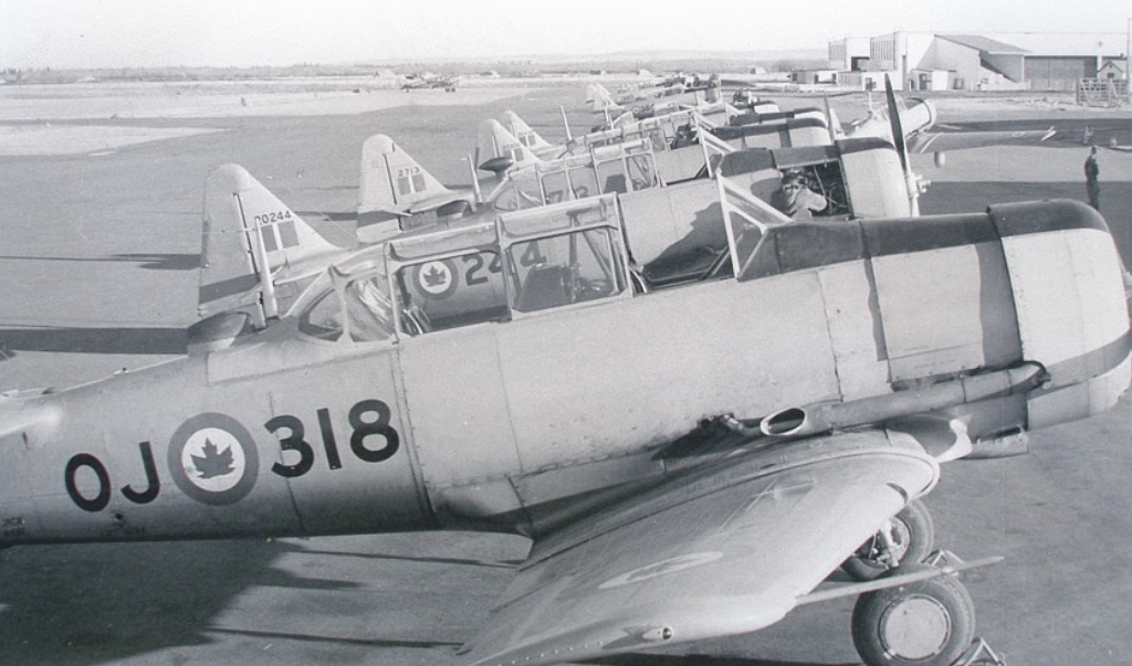 Harvard Historical Aviation Society historical black and white photo of aircrafts lined side by side on the runway