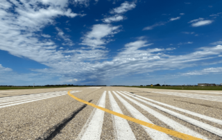 Clouds and blue sky above runway at Red Deer Regional Airport