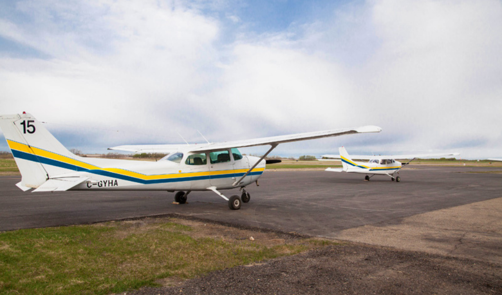Sky Wings Aviation Academy small aircrafts ready for take-off on YQF Airport runway